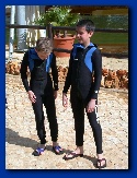 Simon and Michael in wetsuits getting ready for the dolphins